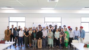 More than two dozen people pose for a group photo at the Sikh listening session on Oct. 22.